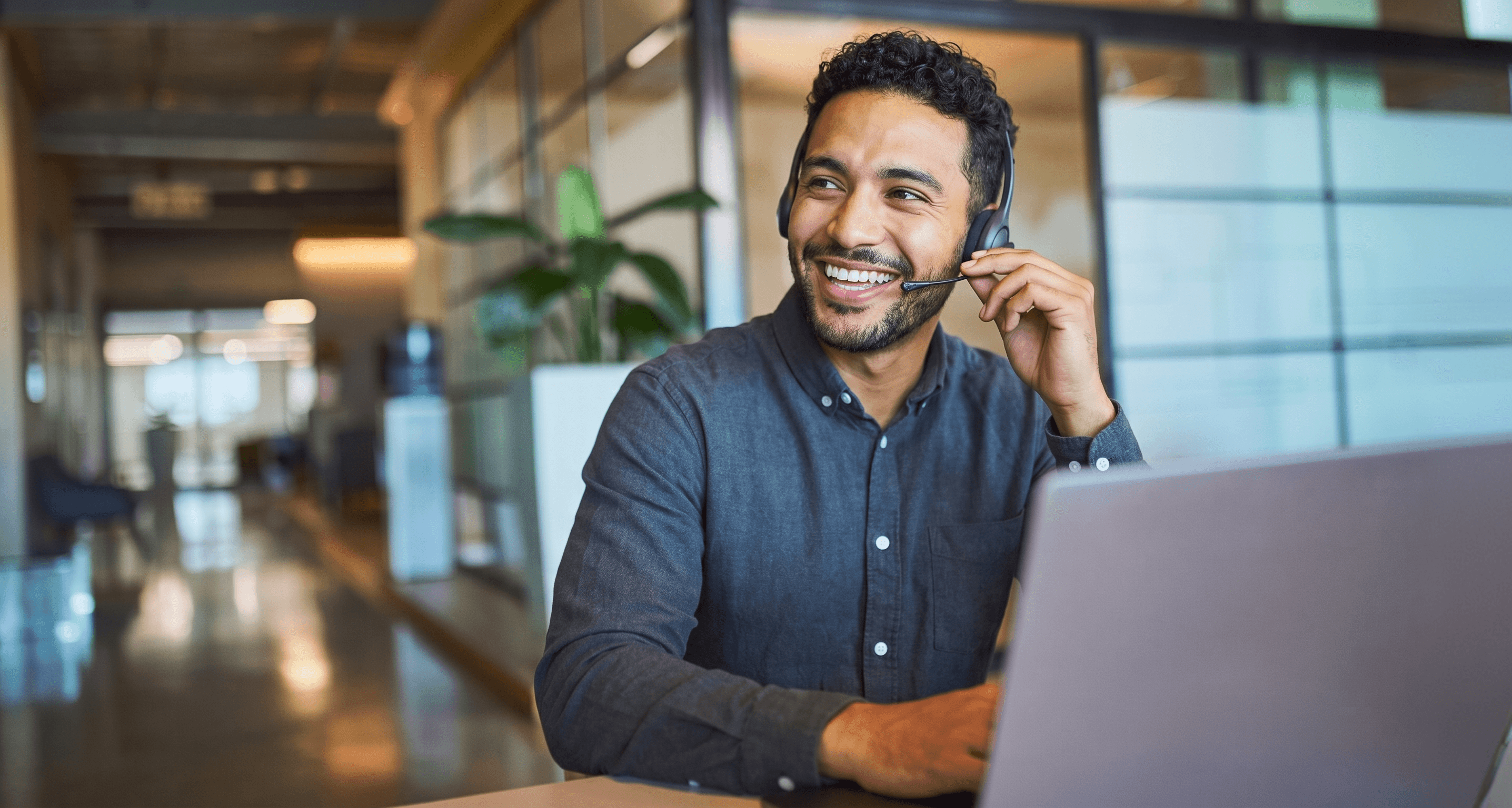 A sales agent on a headset at a desk