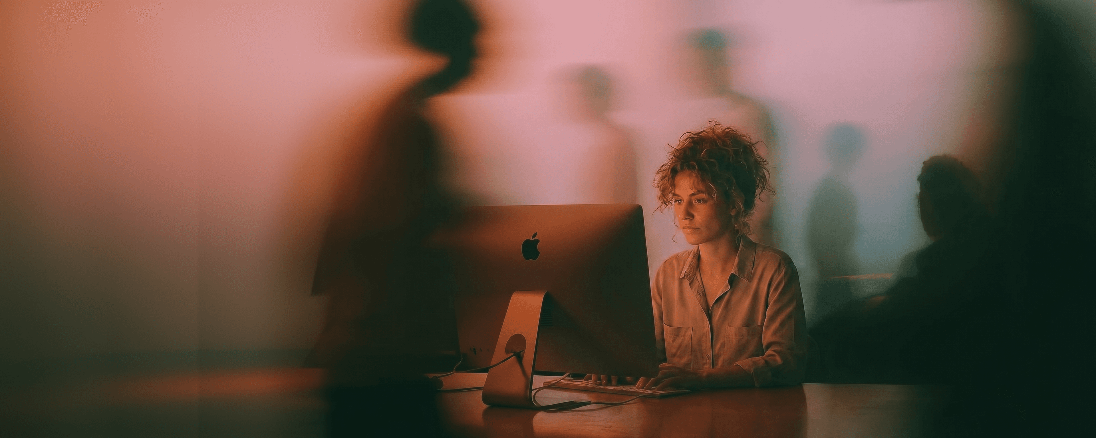 An analyst working at a desk in an open office