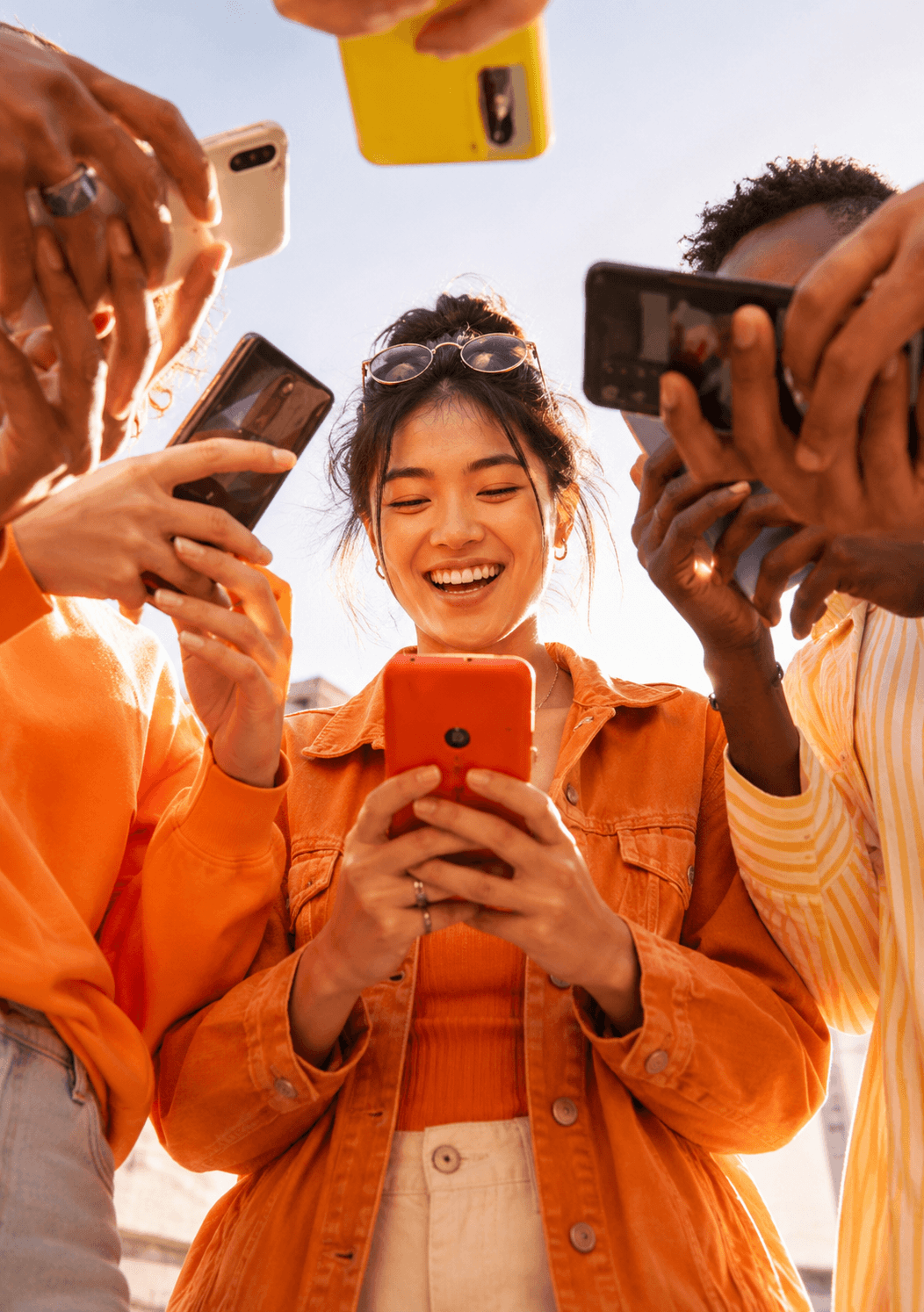 A group of people holding up phones